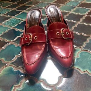 Coach slip on Mules with classic buckle and kitten heels.
